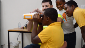 Optometrist refracting students in Dr Alan Glazier's vision care mission to Anguilla