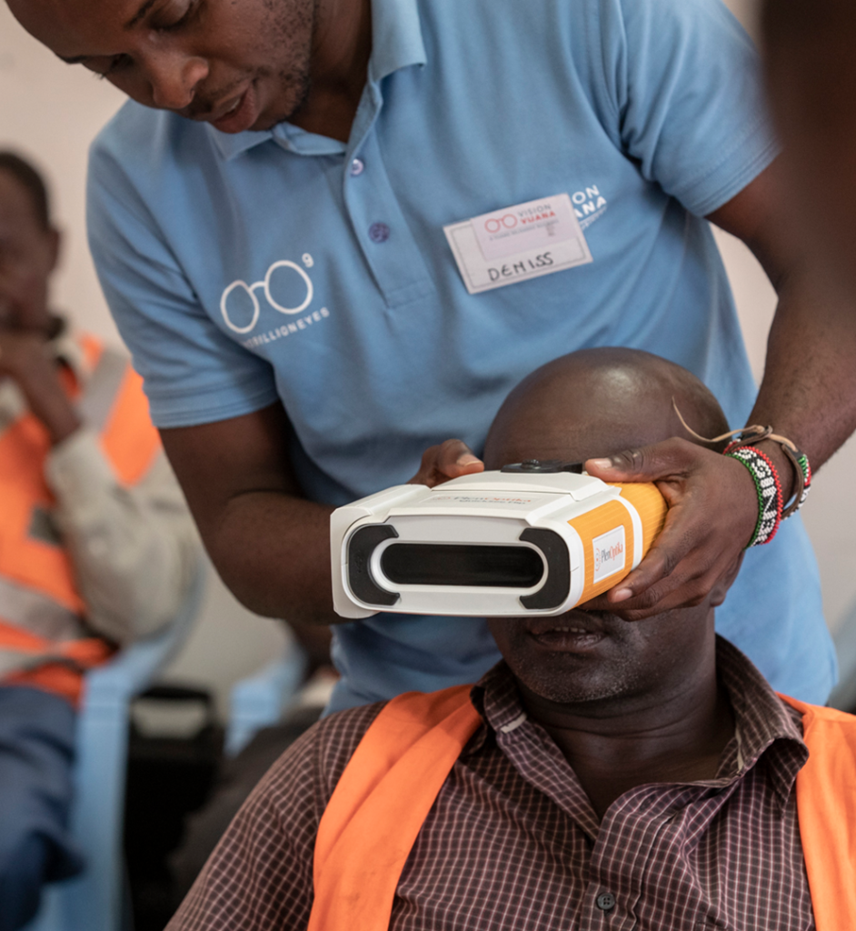 Volunteer using QuickSee for an eye exam on a truck driver